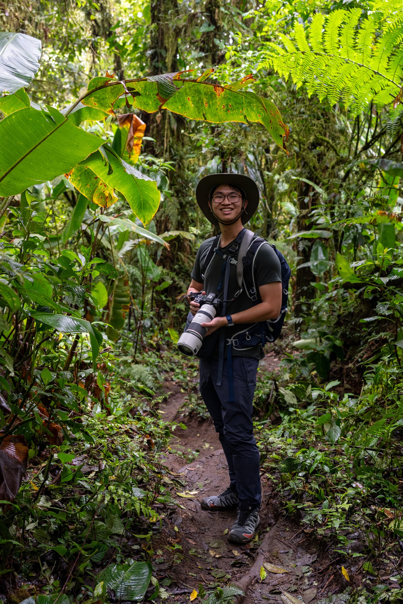 Daniel with his camera in a tropical forest