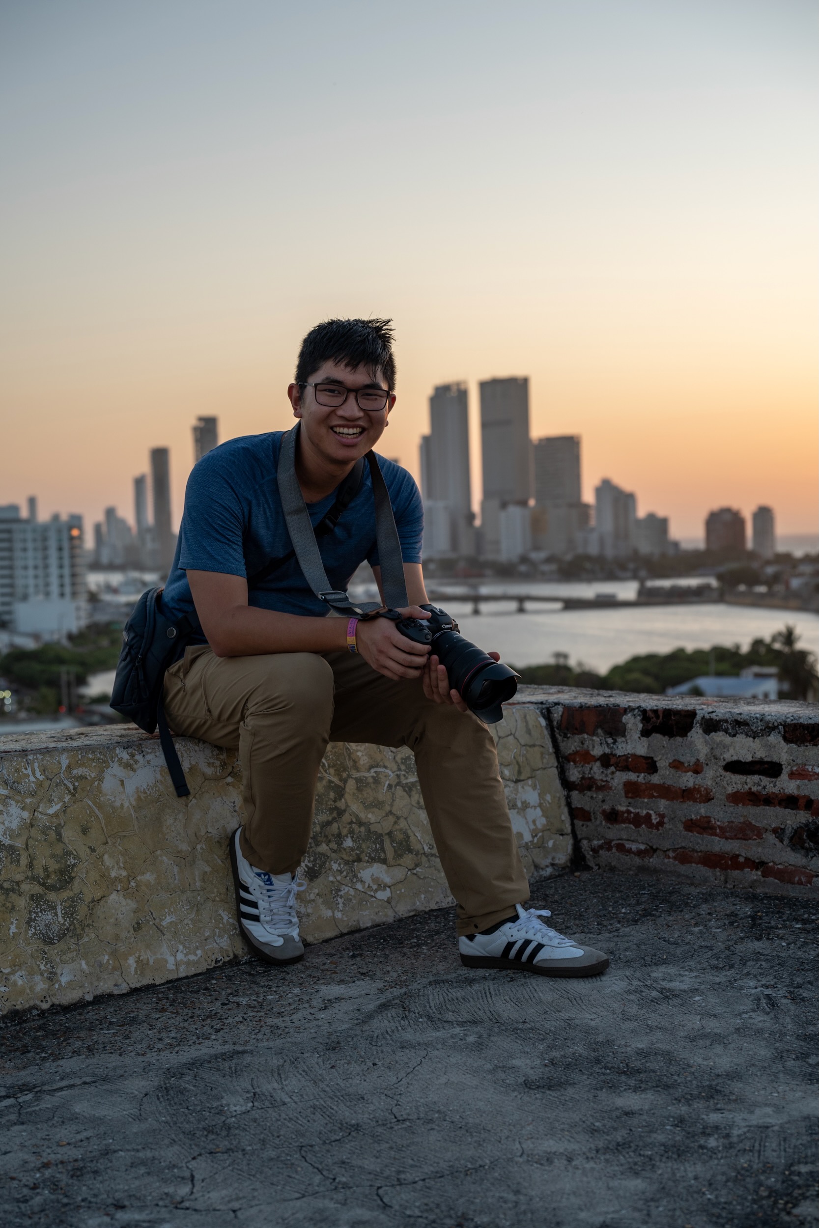 Daniel Zhang holding his camera at sunset
